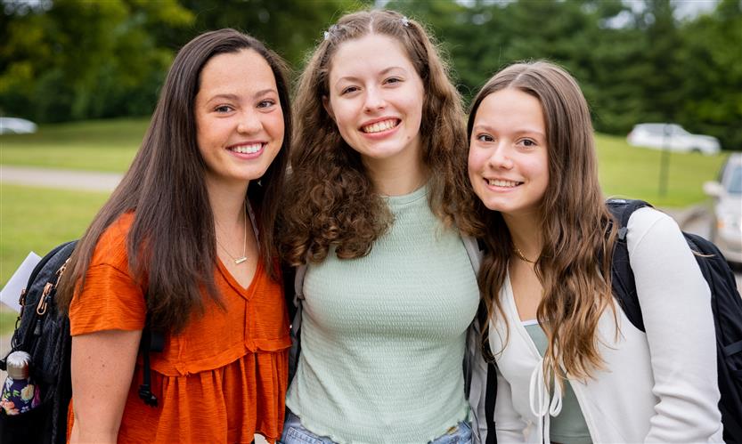 Three girls smile